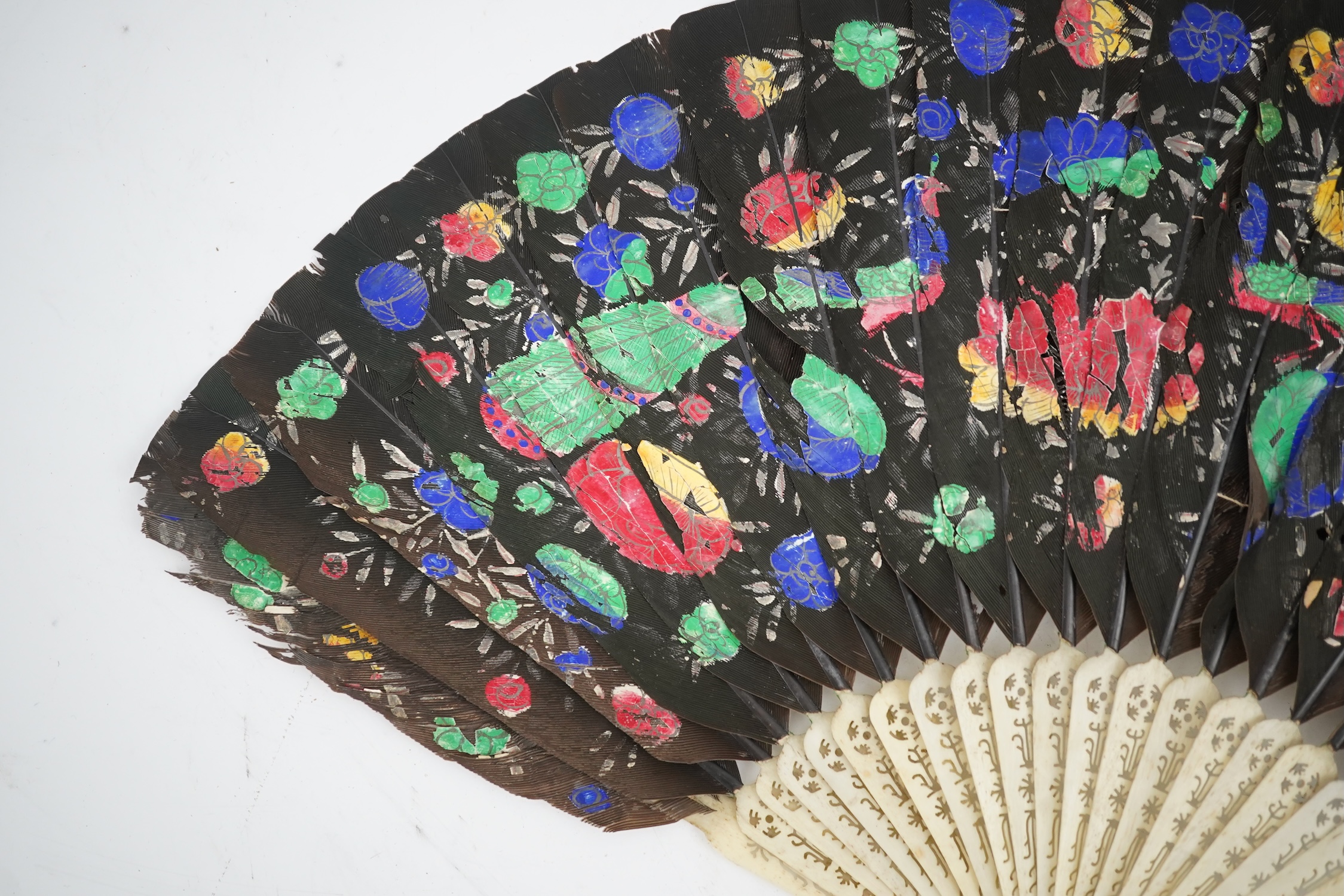 Three 19th century Chinese feather fans: One a carved bone brise black feather fan together with two similar carved sandalwood feather fans, two fans have hand painted decoration on the feathers both sides, the pink feat